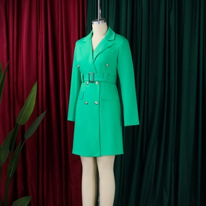 Detail of green double-breasted blazer dress with metallic buttons and waist belt