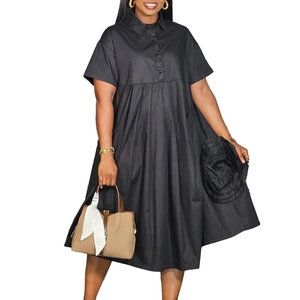 Close-up of black shirt dress featuring a large 3D rose decoration and silhouette hem