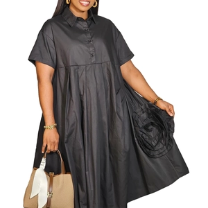 Detail of black shirt dress with oversized floral applique and classic shirt collar