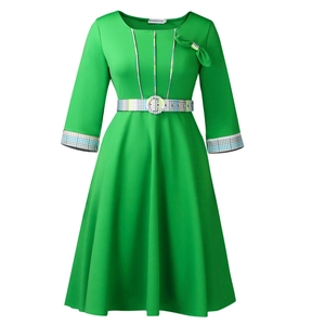 Close-up of retro green A-line dress with round neck, bow detail and plaid pattern belt