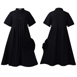 Flat lay of black short sleeve shirt dress with a large 3D flower detail and A-line hem