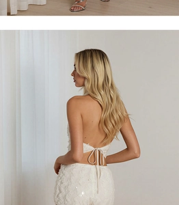 Detail of white sequined halter top with open back and lace textures for party set