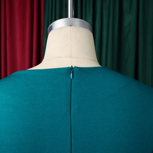 Detail view of the hidden back zipper and textured fabric on the elegant dark green dress