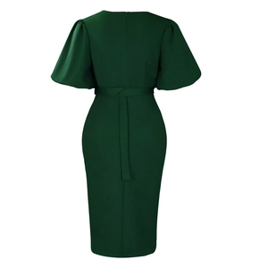 Rear view of dark green V-neck dress with puff sleeves and waist tie detail