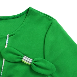 Close-up of elegant round neckline with green bow and gingham ribbon detail on dress