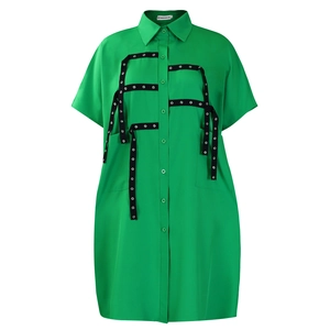 Detail of bright green shirt dress showing silver eyelet trim on the pockets and buttons