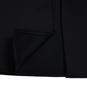 Macro detail of the fine stitching and layered hem of the black evening dress fabric