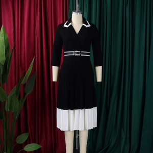 Detail of V-neck patchwork dress with white lapels and pleated skirt for office wear