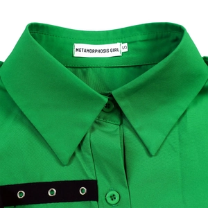Detail of a bright green shirt collar with black eyelet webbing and branded neck label