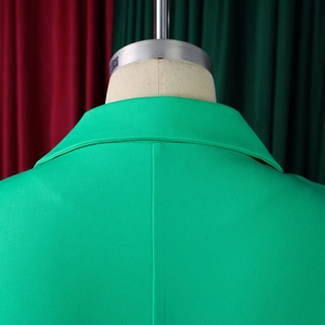 Detail of the bright green blazer dress collar and back seam on a mannequin