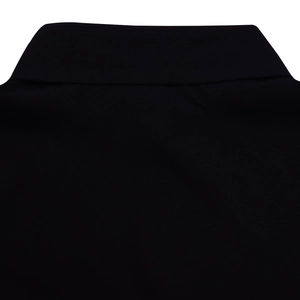 Detailed close-up of the clean neckline and high-quality black cotton fabric of the dress
