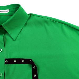 Detail of green shirt collar with black eyelet webbing and branded neck label