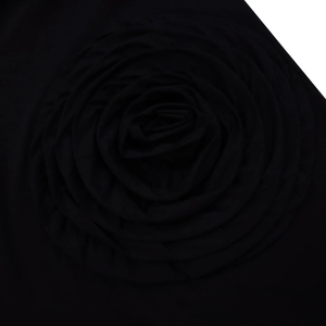Close-up of handmade black 3D fabric rose flower detail on an A-line shirt dress
