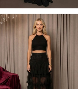 Detail of multi-layered ruffled chiffon skirt with black lace splicing and sheer texture