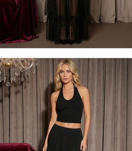 Detail of a black halter neck crop top in premium ribbed knit fabric for a slim fit