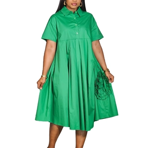 Detail of emerald green shirt dress with lapel collar and unique 3D flower decoration