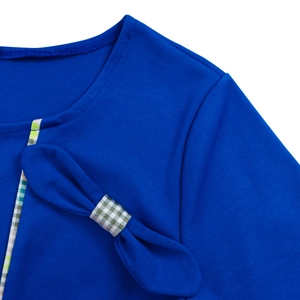 Detail view of royal blue dress with round neckline and green gingham bow decoration