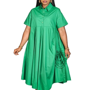 Detail of bright green short sleeve shirt dress with pleats and 3D floral decoration