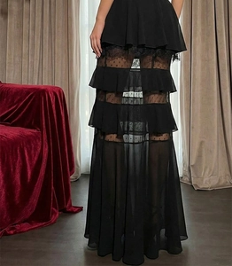 Detail of black tiered maxi skirt with lace patchwork and elegant polka dot mesh layers