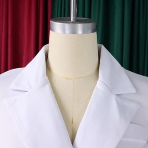 Close-up of white double-breasted blazer dress with notched lapels on a mannequin