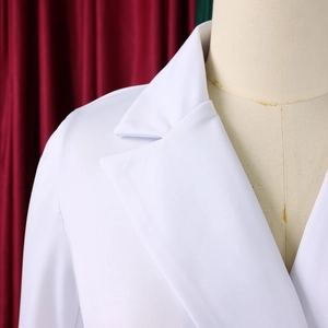 Detailed view of the notched lapel and shoulder of a professional white blazer dress