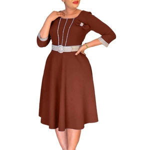 Detail view of brown dress featuring elegant plaid piping and a waist bow decoration