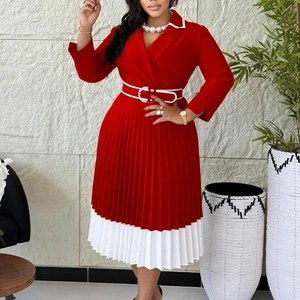 Detail of red and white color-blocked pleated dress with elegant waist belt detail