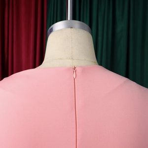 Close-up of pink elegant dress back with invisible zipper and fine twill texture fabric