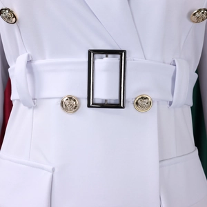 Close-up of golden lion head buttons and black buckle on white blazer dress