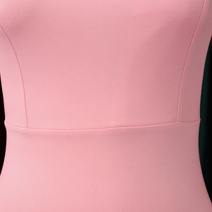 Detail shot of pink slim fit dress showing high-quality knitted fabric texture and stitching