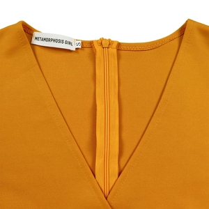 Close-up of V-neckline with invisible zipper on ginger yellow dress with brand label