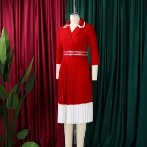 Detail of red and white pleated hem dress with classic lapel and matching waist belt