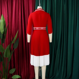 Rear view of long sleeve red dress with white pleated hem and matching waist belt