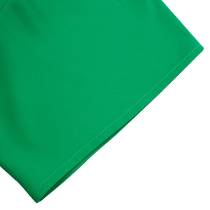 Detailed close-up showing double-row stitching on the bright green A-line dress hem