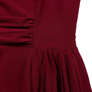 Detail view showing elegant side shirring and pleated texture on wine red dress fabric