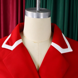 Detail of red long-sleeve dress featuring white lapel contrast and premium woven texture