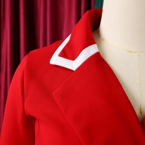 Close-up of red blazer collar with white contrast piping on textured twill fabric