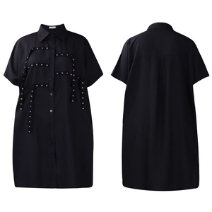 Detail of black short sleeve shirt dress with metallic eyelet straps and lapel collar