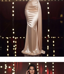 Detail of elegant champagne satin evening gown featuring high waist pleats and side drape