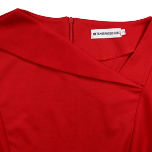 Detail of red dress featuring asymmetric neckline and a hidden back zipper closure