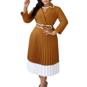 Detail of A-line pleated dress with contrast white hem and waist belt with circular buckle
