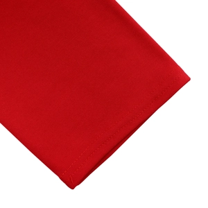 Detailed close-up of double-needle stitching on red cotton knit dress sleeve hem