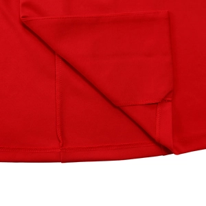 Detail of red knit dress showing neat double-stitched hem and premium fabric texture