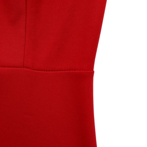 Macro view of high-stretch red knitted fabric showing neat flat seams and fine texture