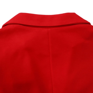 Detail of red blazer collar showing fine knitted texture and precise stitching lines