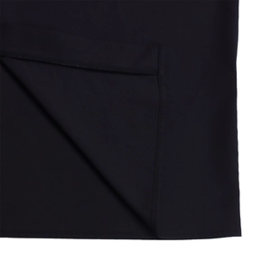 Detail of the high-quality flat-stitched hem on the black mid-length shirt dress