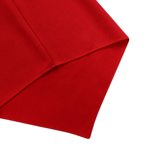 Close-up of red diagonal weave fabric showing detailed overlock stitching on the edge