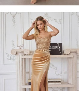 Detailed close-up of champagne gold sequins and velvet high slit evening dress