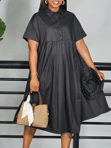 Black short sleeve button-up shirt dress with a large 3D floral accent and flared skirt