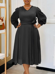 Elegant black plus size V-neck dress with puffy sleeves, pleats, and waist flower detail